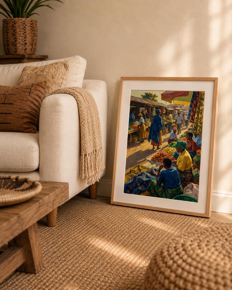 May include: A framed print showing a bustling outdoor market. The artwork displays people in bright clothing, stalls laden with produce, and a sunny ambiance. The frame is a light wood colour.