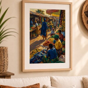 May include: Framed print of a vibrant market scene. The artwork shows people in colourful clothing, trading fruits and vegetables. The market is under a canopy, with sunlight illuminating the scene. The frame is a light wood colour.