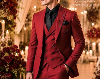 May include: A deep red three-piece suit consisting of a single-breasted jacket, a double-breasted waistcoat with six black buttons, and matching trousers. The suit is worn with a black dress shirt, a black tie, and a black pocket square with a chain.