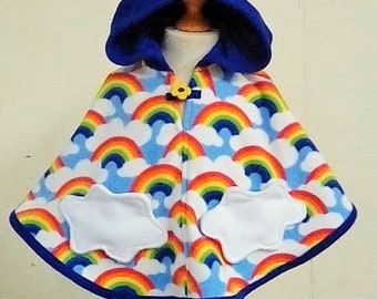 May include: A blue hooded fleece poncho with a rainbow and cloud print. The poncho has two white cloud pockets and a yellow flower button.