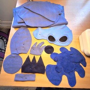 May include: A set of three ceramic mugs with a speckled, matte finish in cream, light grey, and dark grey. Each mug has a simple, modern design and a rounded handle.