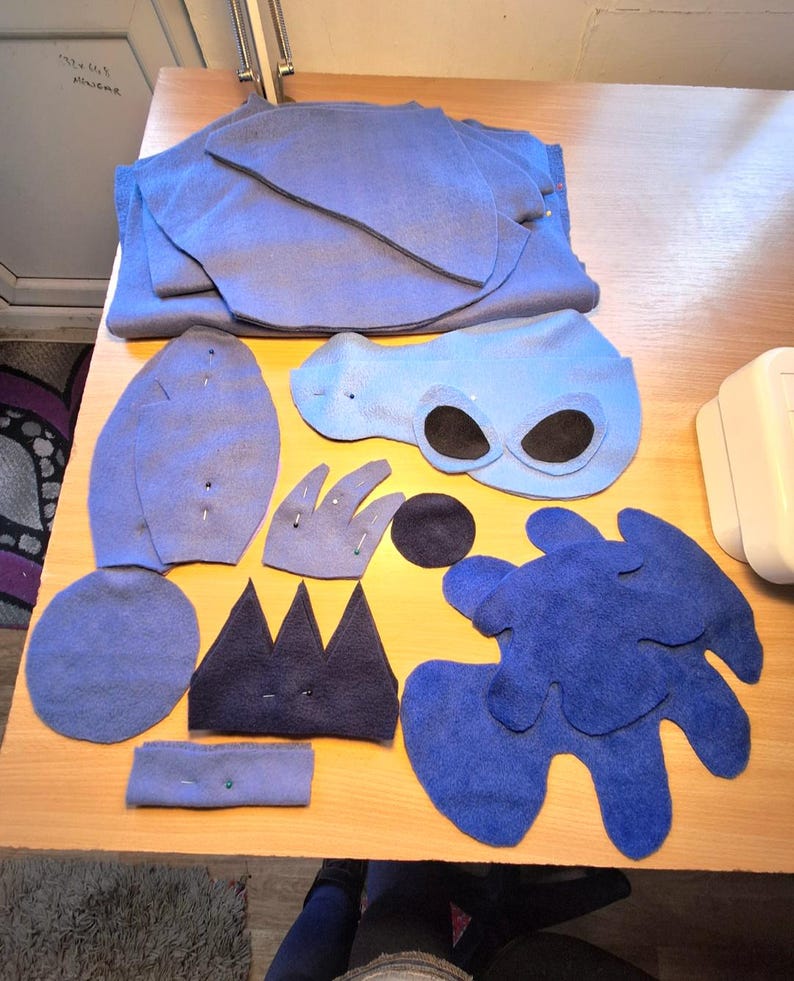 May include: A set of three ceramic mugs with a speckled, matte finish in cream, light grey, and dark grey. Each mug has a simple, modern design and a rounded handle.