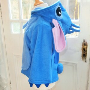 May include: A set of three ceramic nesting bowls in graduating sizes. The bowls are white with a speckled, textured finish and feature a slightly flared rim. Suitable for food preparation or serving.