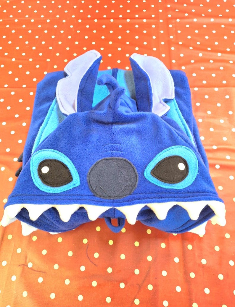 May include: A white ceramic mug with a black handle and the text "But First, Coffee" in a bold, black font. The mug is on a white surface. The mug is approximately 10 cm tall.