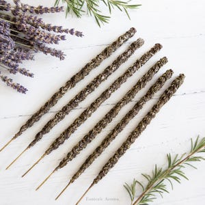 6 incense sticks on a white background with lavender and rosemary nearby