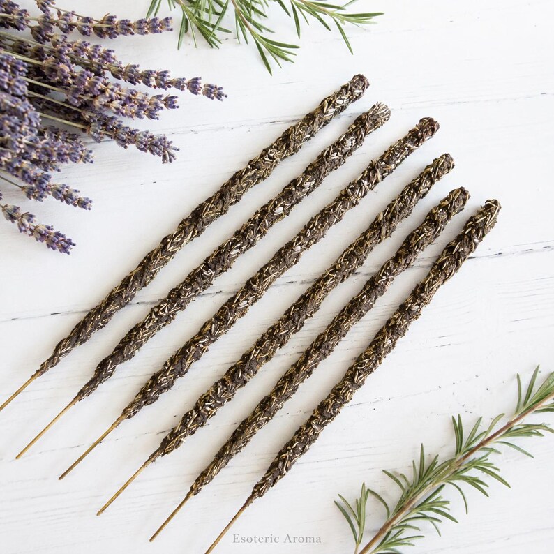 6 incense sticks on a white background with lavender and rosemary nearby