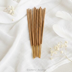 Incense sticks on a white fabric background with 'Esoteric Aroma' branding.