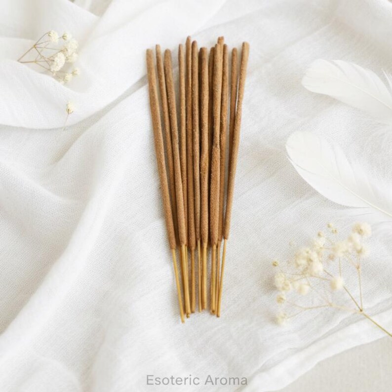 Incense sticks on a white fabric background with 'Esoteric Aroma' branding.