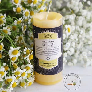 May include: Yellow candle with a black label that reads "Astro Magic Full Moon Let it Go" with a star pattern and the text "Coventry Creations Storm Cestaina".