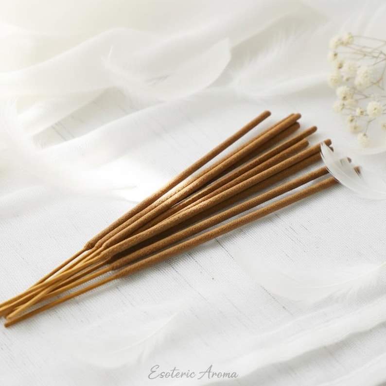 Incense sticks on a white fabric background with 'Esoteric Aroma' branding.