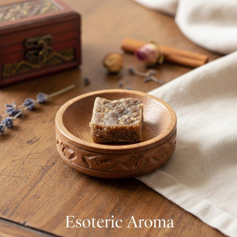 Square of amber resin incense in a wooden dish on a wooden surface with 'Esoteric Aroma' text.