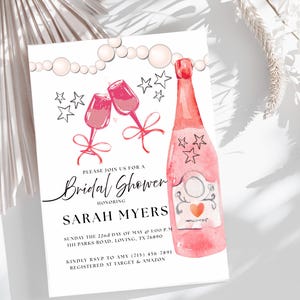May include: A watercolor-style bridal shower invitation featuring a pink champagne bottle and two champagne flutes. The invitation includes the text "Bridal Shower" and details for Sarah Myers' shower.