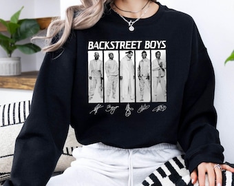 May include: Black crewneck sweatshirt featuring the text "BACKSTREET BOYS" above a black and white image of the band members. The image includes the band members' signatures. The sweatshirt is a comfortable, casual style.