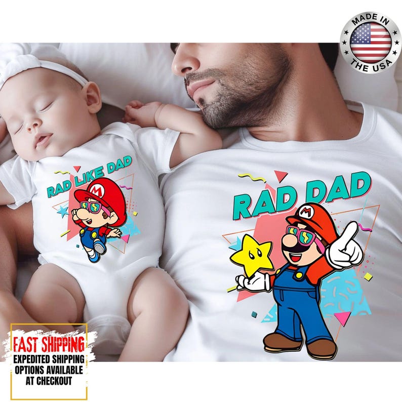 May include: White t-shirts with a cartoon graphic of a character wearing sunglasses and a red hat. The text "RAD DAD" is printed on one shirt and "RAD LIKE DAD" on the other. The shirts are made in the USA.