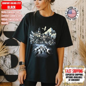 May include: Black Comfort Colors 1717 t-shirt featuring a graphic of a castle, mountains, and a bird. The shirt has the text "MADE IN THE USA" and "FAST SHIPPING" on it. The shirt is a Bella+Canvas Tee, Comfort Colors Tee, and Gildan Sweatshirt & Hoodie.