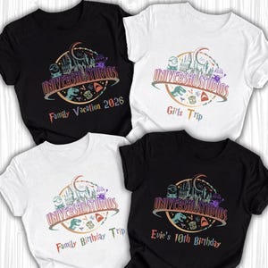 May include: Four t-shirts with the Universal Studios logo. Two are white and two are black. The shirts have different text: "Family Vacation 2026", "Girls Trip", "Family Birthday Trip", and "Evie's 10th Birthday". The logo includes cartoon characters and park imagery.