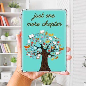 May include: A light blue tablet case featuring a brown tree illustration with open books, red apples, and colorful flowers as leaves. The text "just one more chapter" is printed in brown script at the top of the rectangular protective cover.