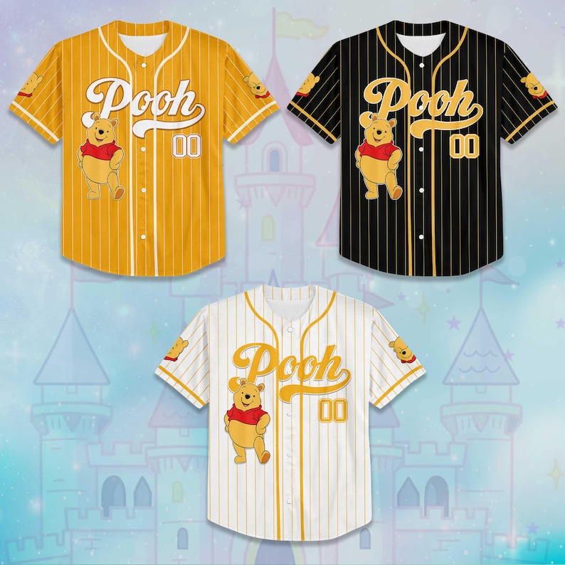 May include: Three baseball jerseys featuring the character Pooh. The jerseys are yellow, black, and white with vertical stripes. Each jersey has the word "Pooh" in script, the number "00", and a cartoon image of Pooh.