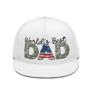 May include: A white baseball cap featuring the text "World's Best DAD". The letters "DAD" are in a camouflage pattern with the American flag in the letter "A". The text "World's Best" is in black script.