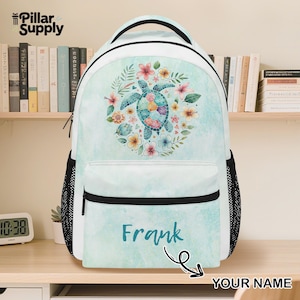 May include: White backpack with a teal watercolor background and a colorful turtle design surrounded by flowers. The backpack has a black handle, black mesh side pockets, and the name "Frank" in teal script.