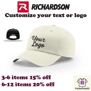 May include: Cream-colored baseball cap with the text "Your Logo" in black script. The image also shows a black cap and the Richardson logo. Text reads "Customize your text or logo."