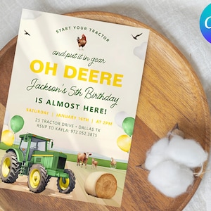 May include: A farm-themed birthday invitation with the text "OH DEERE" and "Jackson's 5th Birthday." The invitation features a green tractor, farm animals, and hay bales. The invitation is on a wooden tray with cotton.