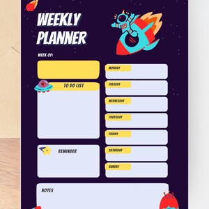 May include: A dark blue weekly planner with a space theme. The planner features a rocket ship, an astronaut, and a UFO. The text "WEEKLY PLANNER" is at the top. Sections include "TO DO LIST", "REMINDER", and daily entries for the week.