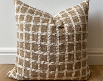 May include: A brown and white checkered throw pillow with a woven texture.