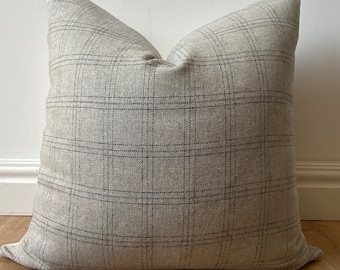 May include: A large, square, gray and white plaid throw pillow with a subtle sheen.