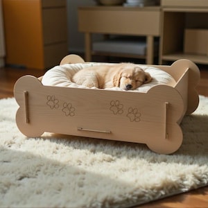 May include: A light-colored wooden dog bed in a bone shape, with paw print cutouts. A small, sleeping puppy rests on a soft, cream-colored cushion inside the bed. The bed sits on a fluffy, cream-colored rug.