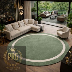 May include: A large, circular, green rug with a thick white border. The rug is in a living room setting with a beige sectional sofa, a white armchair, and a view of an outdoor patio. The rug is from Prime Rugs Gallery.