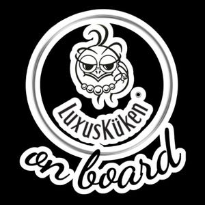 May include: A black and white sticker featuring a cartoon owl with a pearl necklace and a ring. The text "LuxusK&uuml;ken on board" is written in a stylized font, enclosed in a white circle.