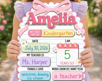 May include: A personalized first day of kindergarten sign with a lined paper background, a pink bow, and floral accents. It features the name Amelia, the date July 30, 2026, teacher Ms. Harper, age 5, and interests including unicorns, drawing, and ice cream.