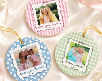May include: Three round ceramic ornaments featuring custom photo prints. One has pink stripes with "Love you Besties", one has blue polka dots with "Love you Besties", and one has green gingham with "Besties Forever". Each has a gold hanging cord.