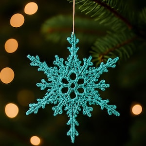May include: A turquoise blue crocheted snowflake ornament featuring a six-pointed star design with intricate openwork patterns and a central circular motif, suspended by a thin metallic gold thread for hanging on a tree branch.