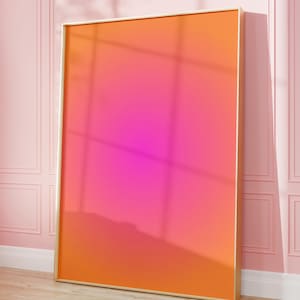 May include: A rectangular wall art piece featuring a vibrant gradient that transitions from a bright orange at the top and bottom edges to a deep, saturated magenta pink in the center, all encased within a thin, light-colored wooden frame.