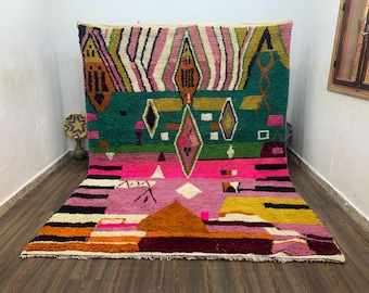 May include: A vibrant, geometric rug with a mix of colors including pink, green, yellow, and orange. The rug features diamond and triangle shapes, with a textured, woven appearance. The design is bold and eye-catching, suitable for a living room or bedroom.