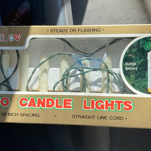 May include: A box of 10 Everglow candle lights with a UL safety certification. The lights are super bright and have a 10-inch spacing. The box says "Steady or Flashing" and "Straight Line Cord".