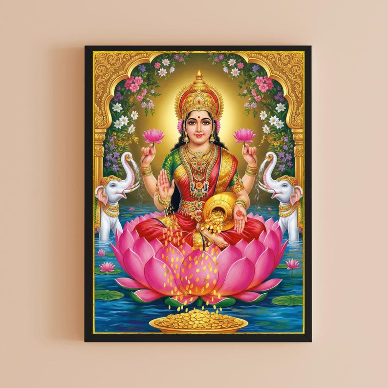 May include: A framed print of the Hindu goddess Lakshmi, seated on a pink lotus flower. She wears a red sari, gold jewelry, and a crown. Two white elephants flank her, and a golden pot overflows with coins. The background features a golden archway and floral accents.