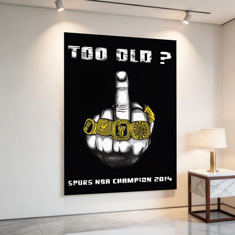May include: A black wall poster featuring a white illustration of a hand making a middle finger gesture. The fingers are adorned with four gold championship rings. The text "TOO OLD ?" appears at the top and "SPURS NBA CHAMPION 2014" at the bottom.