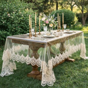 May include: A white ceramic mug with a black handle and the text "But First, Coffee" in a bold, black font. The mug is set against a blurred background, suggesting a cosy setting.