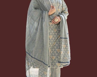 May include: A grey and beige three-piece outfit consisting of a long-sleeved tunic, matching trousers, and a large shawl. The fabric features a repeating leaf pattern in beige on a grey background, with a striped texture on the shawl and tunic.