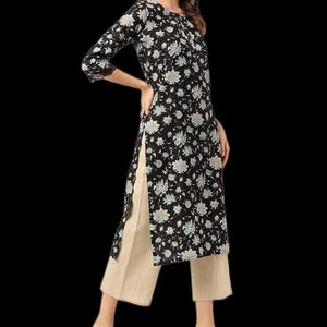 May include: A black floral print tunic with three-quarter sleeves and side slits, paired with beige cropped pants. The tunic features a round neckline and a delicate floral pattern in white and light blue.