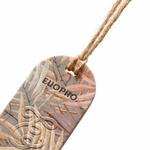 May include: An oval-shaped tag with a watercolor leaf design in shades of gray, peach, and brown. The tag features the word "EUOPHO" and the phrase "encounter love" in black text. A natural twine string is attached at the top.