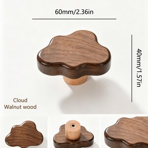 May include: A cloud-shaped cabinet knob made of dark walnut wood with a lighter wood base. The knob measures 60mm or 2.36 inches in width and 40mm or 1.57 inches in height. The text "Cloud Walnut wood" is printed near the knob.