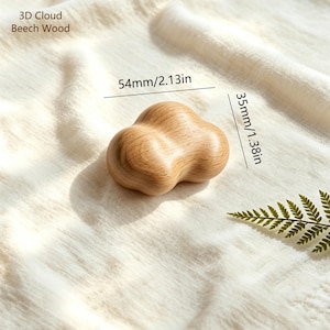 May include: A 3D cloud-shaped object made of beech wood. The object features a smooth, light brown wood grain finish. Text in the image reads 3D Cloud Beech Wood. Dimensions are indicated as 2.13 inches in width and 1.38 inches in height.