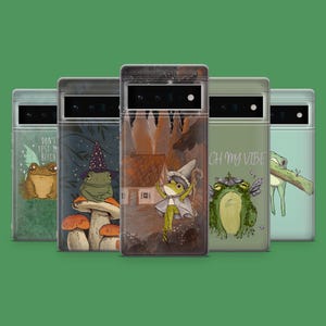 May include: Five phone cases with whimsical frog illustrations. One case features a frog with wings and the text "DON'T TEST MY BITCH". Another shows a frog wearing a witch hat on a mushroom. Other cases have frogs with fairy wings and a frog holding a branch. The cases are on a green background.