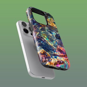 May include: A silver smartphone with a colorful, patterned phone case. The case features a design of rippling water in shades of blue, orange, and purple. The phone case is black around the edges.