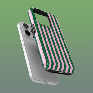 May include: A silver smartphone with a protective case. The case has a vertical striped pattern in green and pink. The phone case is designed to protect the phone from damage.