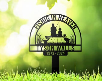 May include: Black metal memorial garden stake with the words "Fishing in Heaven" and the name "Tyson Walls" with the years 1973-2024. The design features a silhouette of a person and child fishing on a dock.